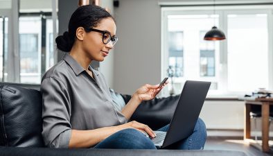 Woman with a credit card using a laptop